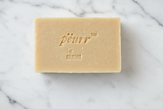 Bar of soap with 'Peurr' branding with the scent 'Elemi' engraved on it