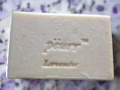 A bar of lavender goat milk and olive oil soap with the brand name 'PÈURR®' stamped on the top.