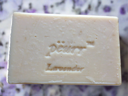 A bar of lavender goat milk and olive oil soap with the brand name 'PÈURR®' stamped on the top.