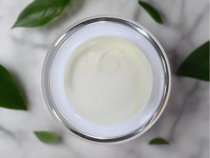 Jar of body butter with lid off showing creamy product.